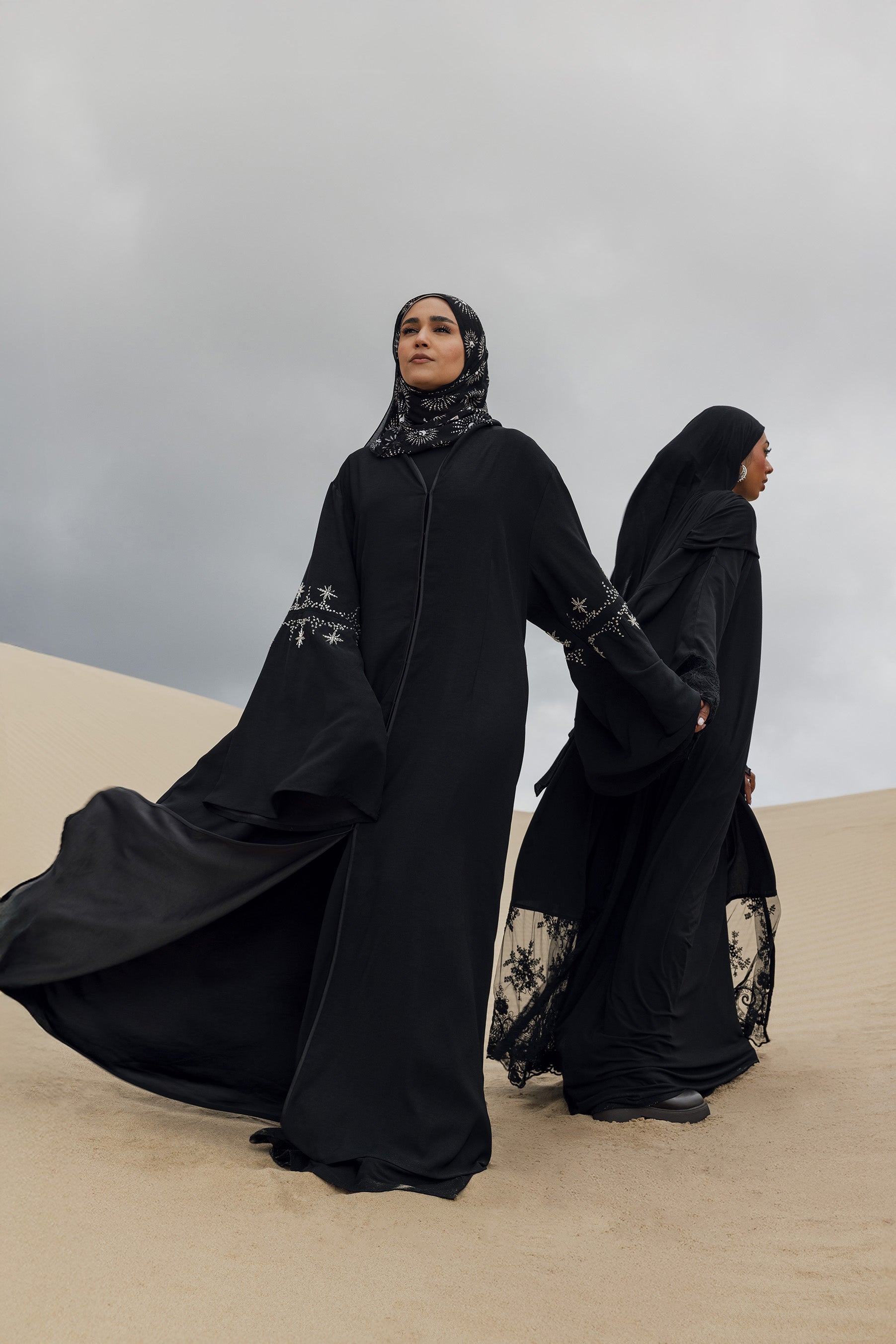 Opulent abaya featuring flared cuffs and soft embellishments throughout