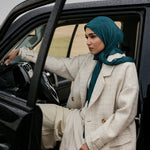 Structured outerwear piece designed for full coverage with classic trench coat appeal
