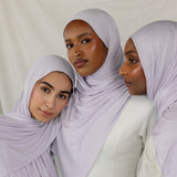 Three models wearing Soft Amethyst Jersey Lite, capturing its soft purple tone from different angles.