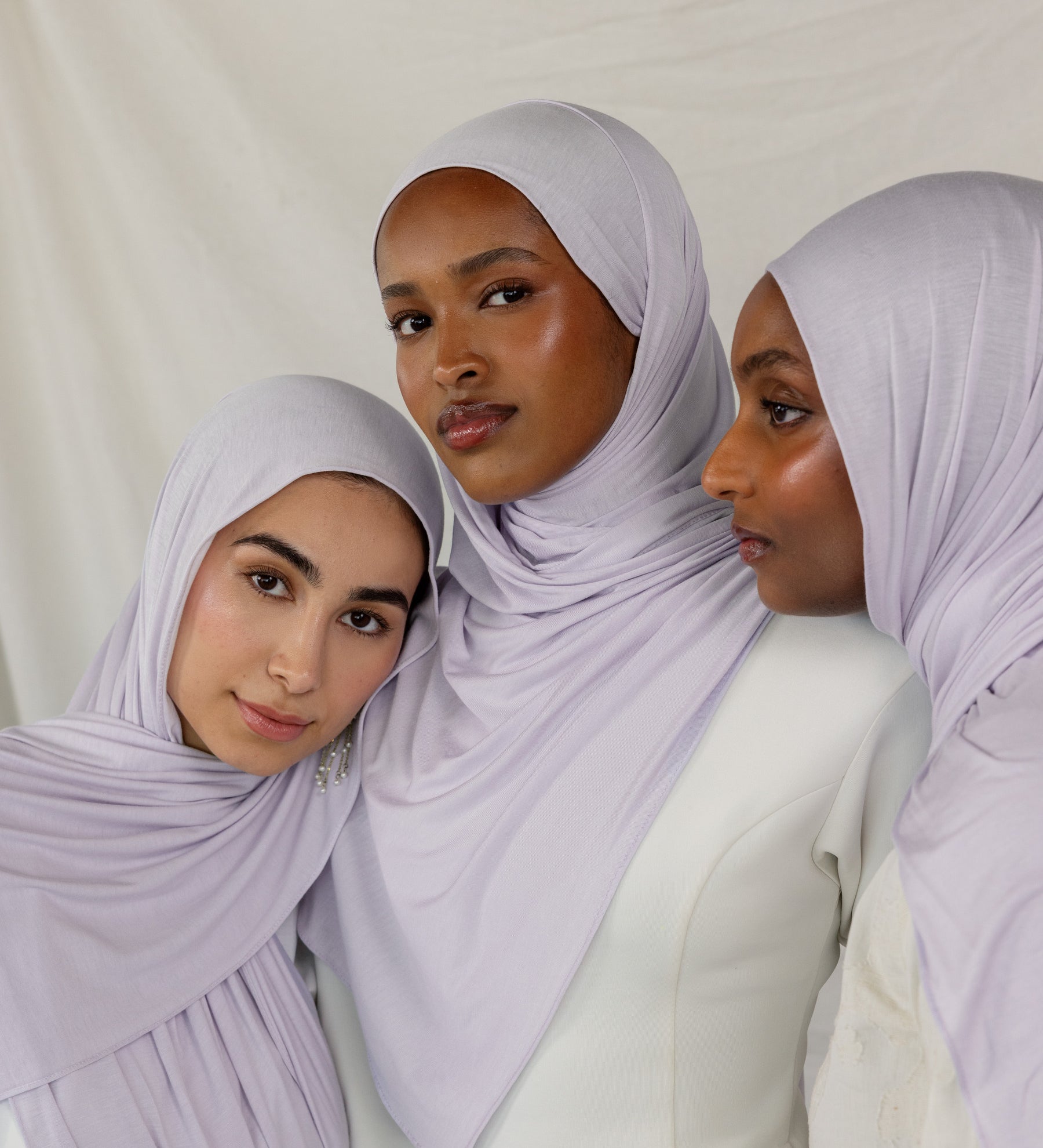 Three models wearing Soft Amethyst Jersey Lite, capturing its soft purple tone from different angles.
