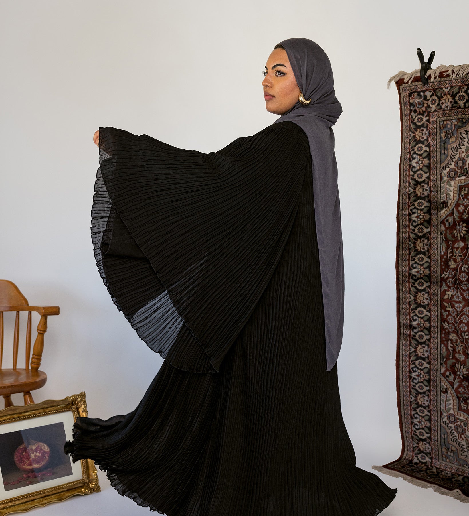 Elegant abaya featuring fine pleats and lightweight movement for easy styling.