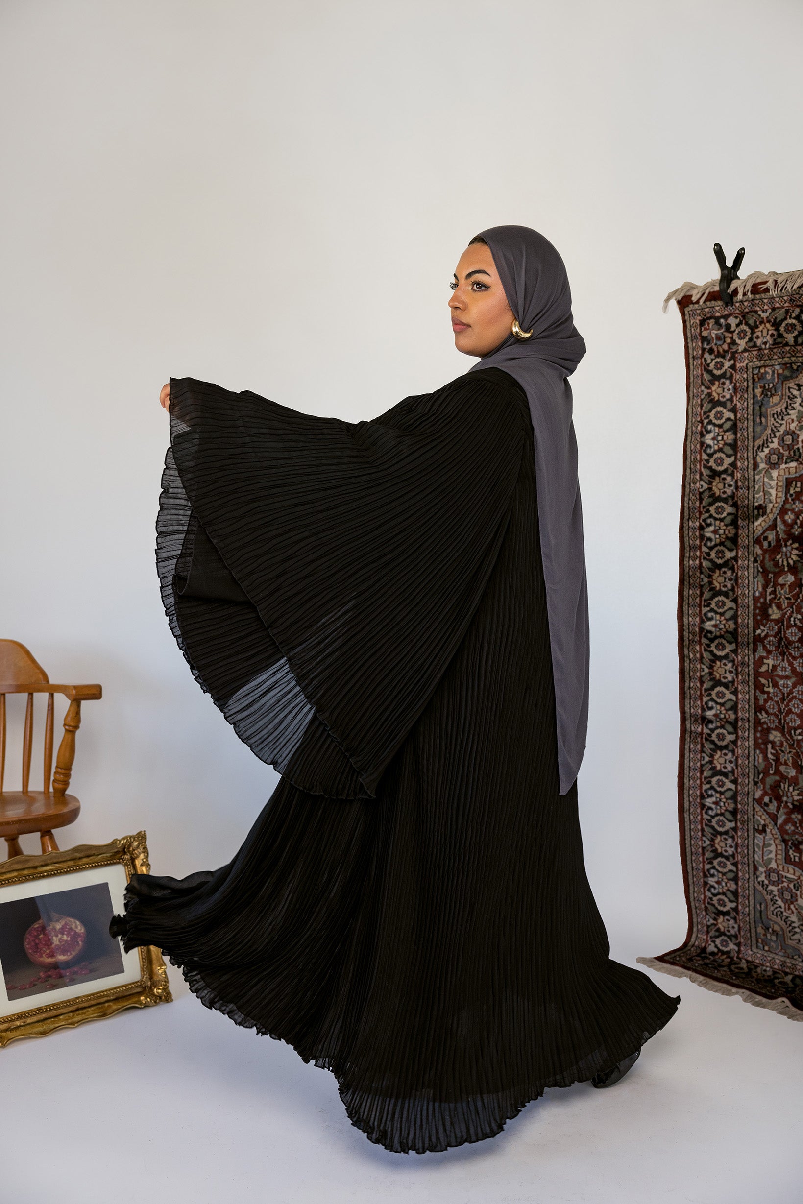Elegant abaya featuring fine pleats and lightweight movement for easy styling.