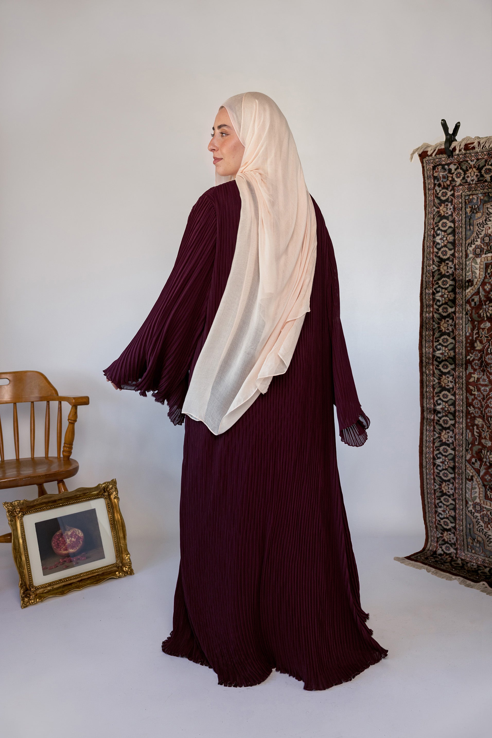 Soft pleated abaya with fluid drape, perfect for dressing up or wearing simply.