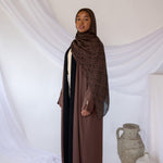 Reversible abaya with two-tone design and flowing drape for versatile styling.