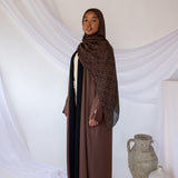 Reversible abaya with two-tone design and flowing drape for versatile styling.