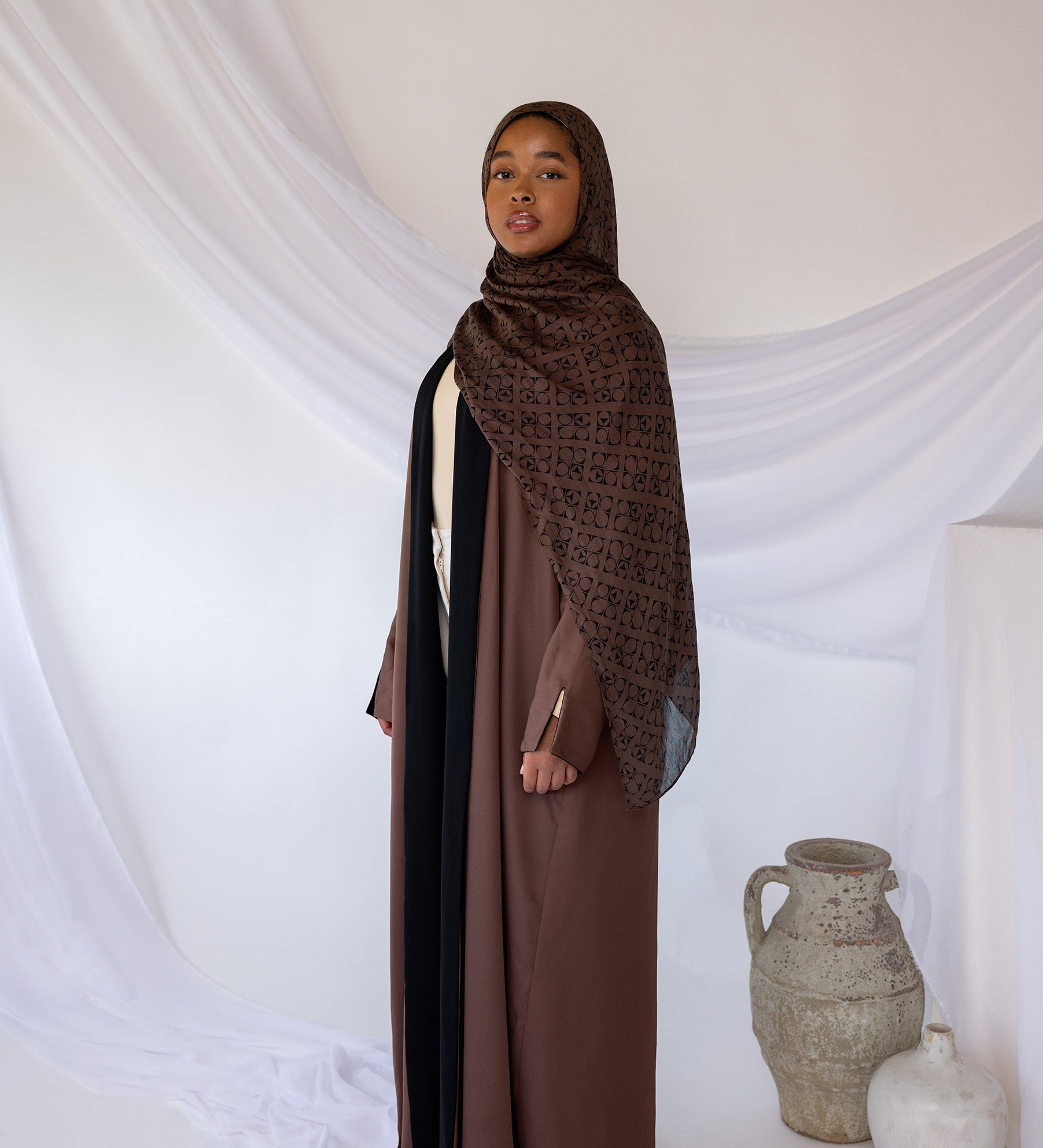 Reversible abaya with two-tone design and flowing drape for versatile styling.