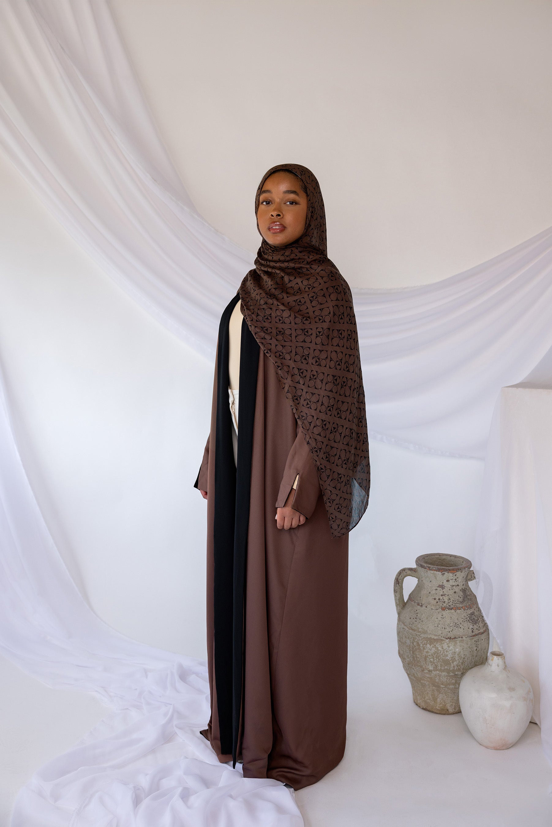 Reversible abaya with two-tone design and flowing drape for versatile styling.