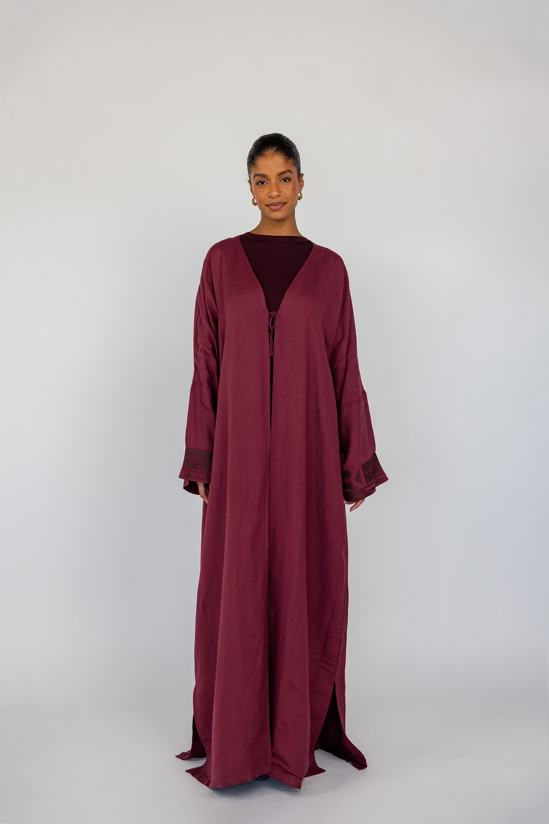 A modern revival of tradition abaya with stitched detail on the back and a breathable finish