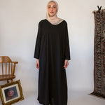 Black full-length underdress with a smooth finish, perfect for layering or wearing solo