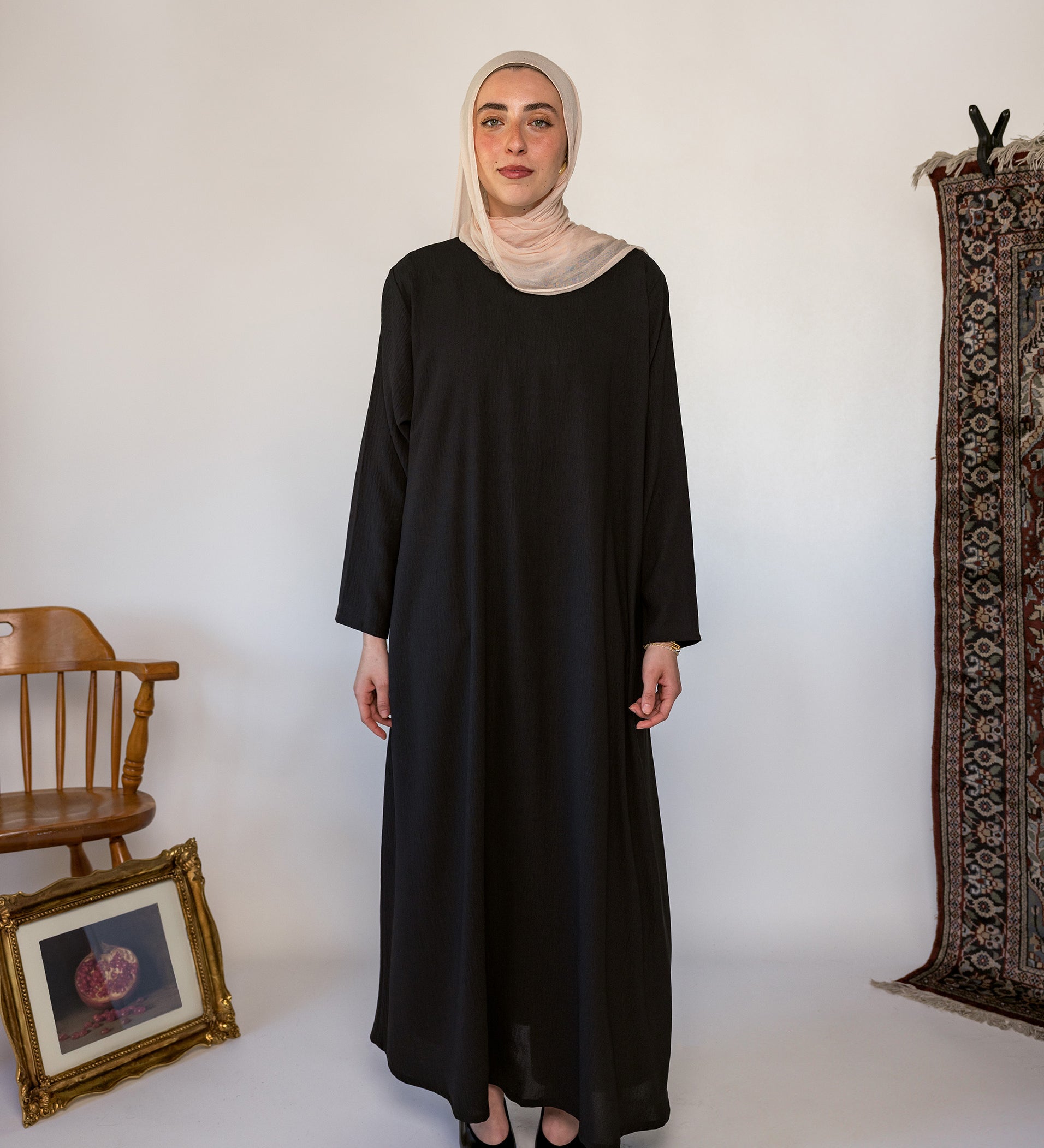 Black full-length underdress with a smooth finish, perfect for layering or wearing solo
