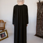 Minimal black underdress with breathable fabric and a sleek, modest fit.