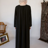 Minimal black underdress with breathable fabric and a sleek, modest fit.