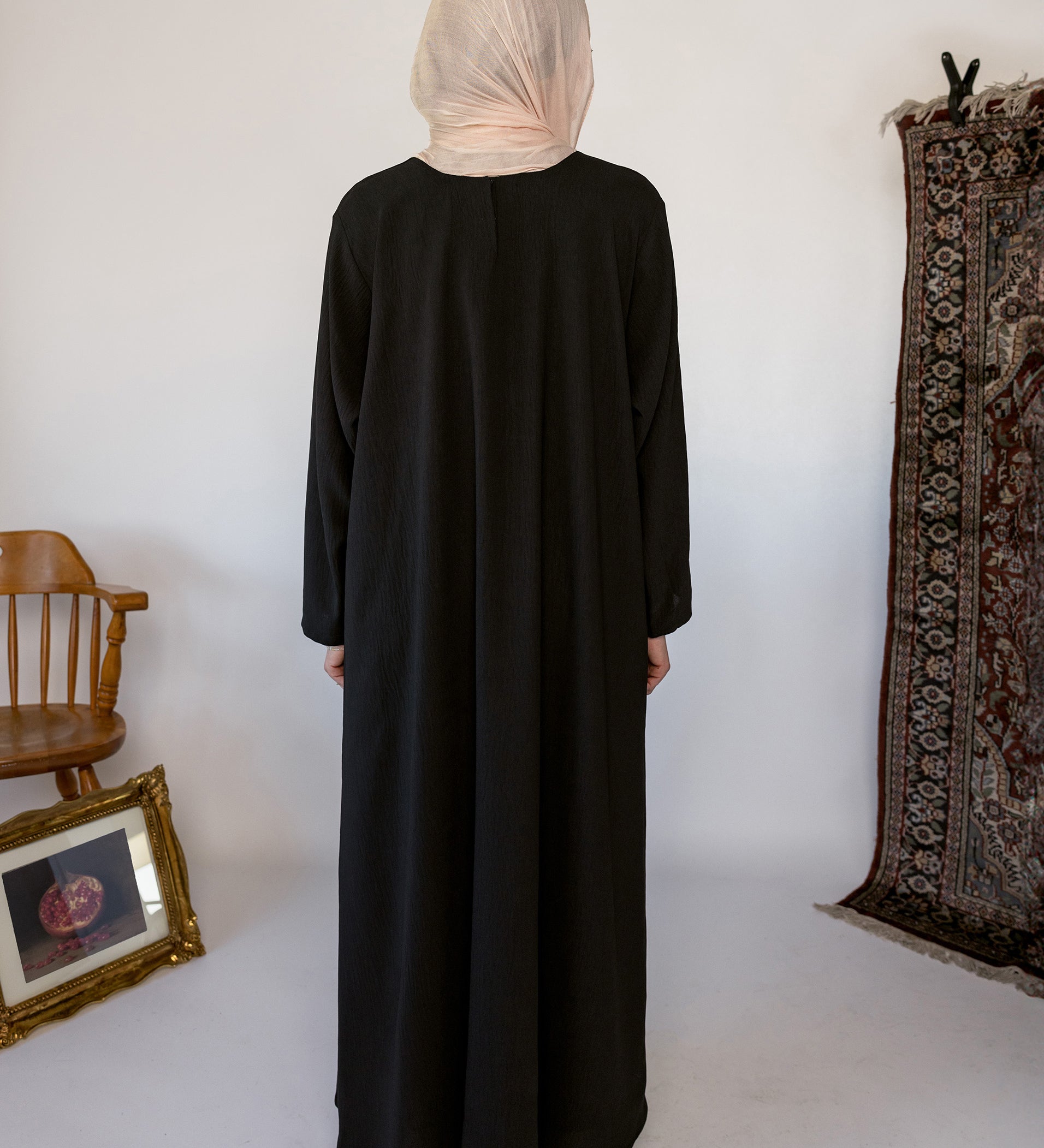 Minimal black underdress with breathable fabric and a sleek, modest fit.
