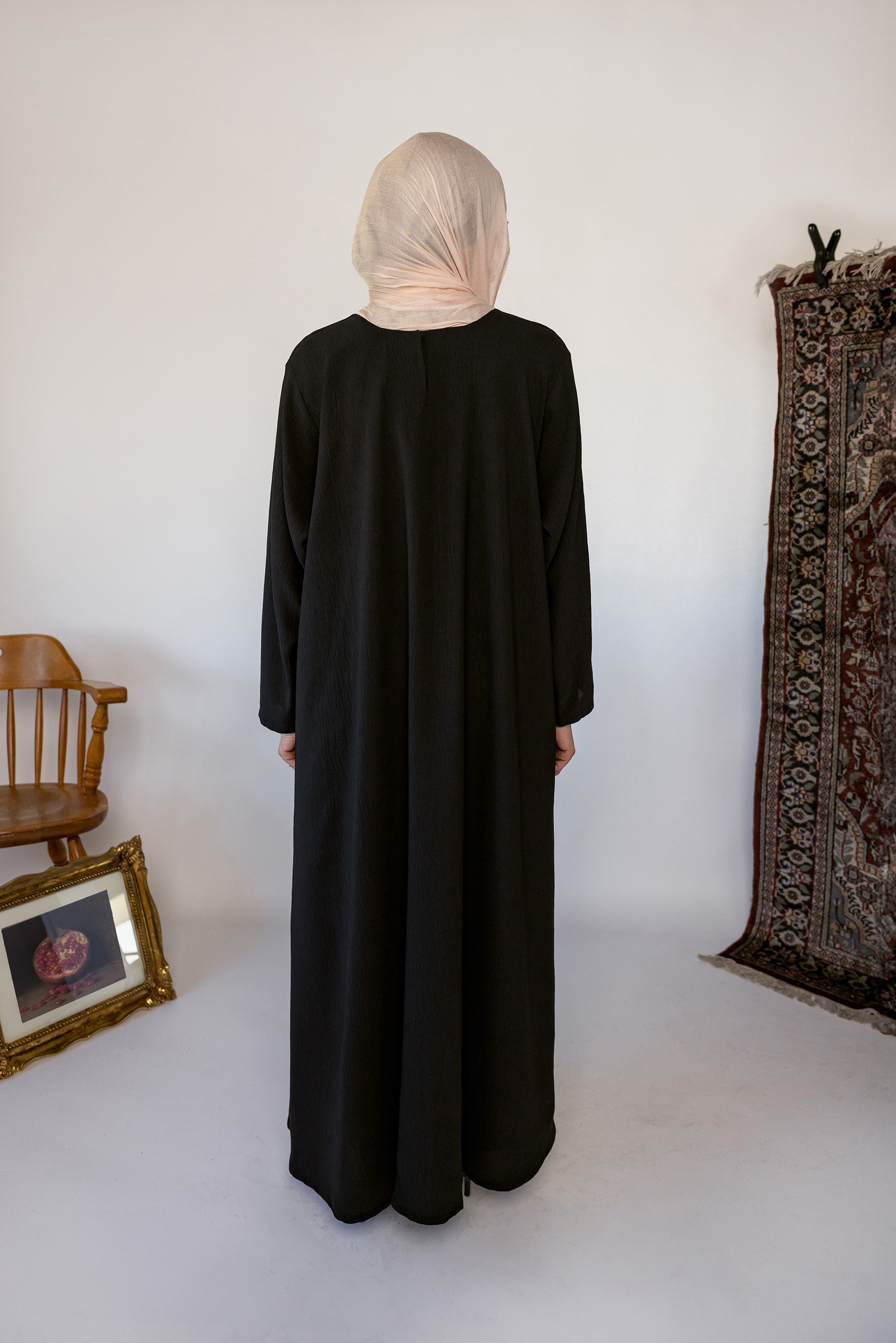 Minimal black underdress with breathable fabric and a sleek, modest fit.