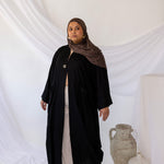 Linen abaya with discreet side pockets and a clean, minimalist design.