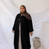 Linen abaya with discreet side pockets and a clean, minimalist design.