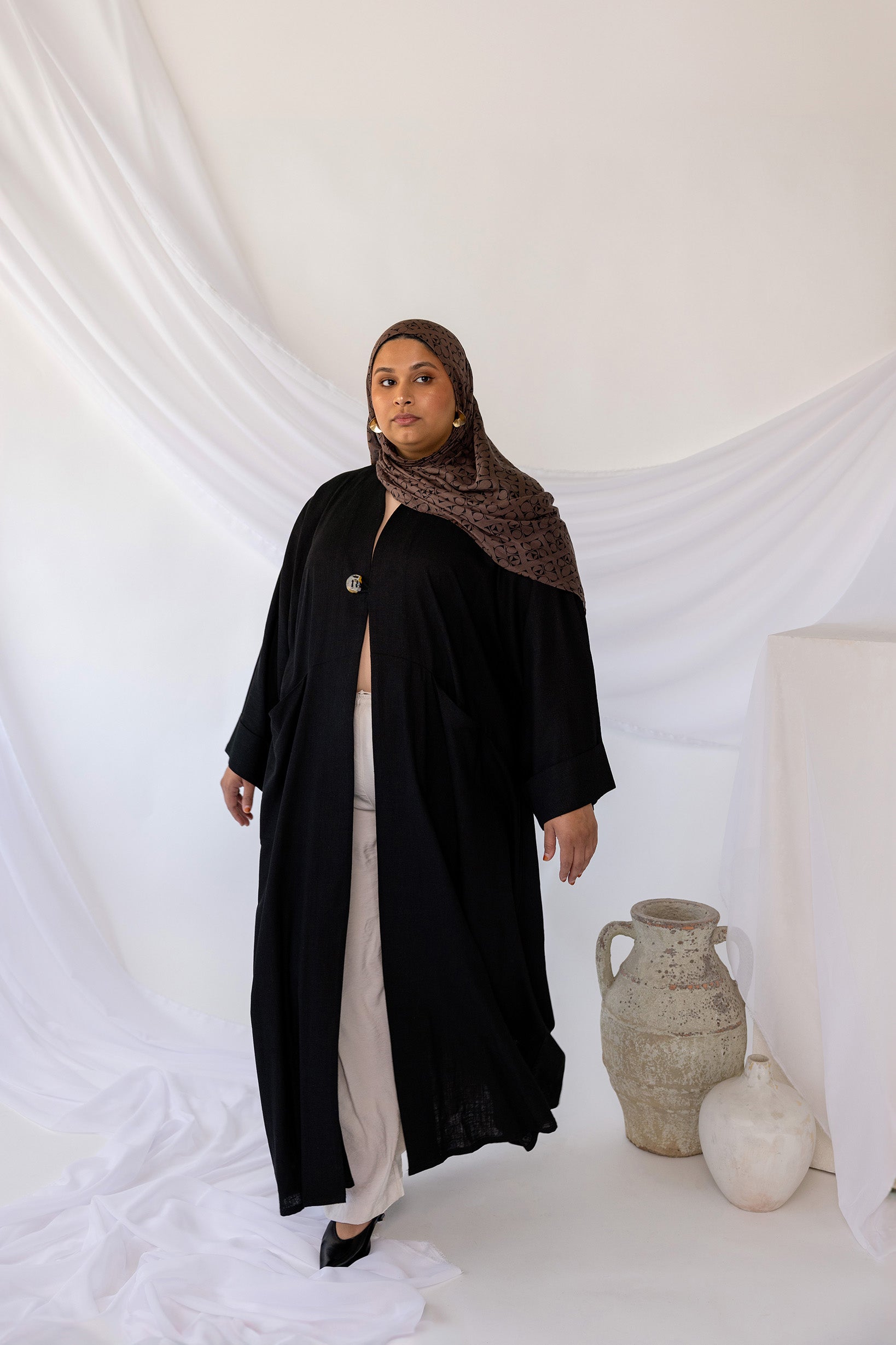 Linen abaya with discreet side pockets and a clean, minimalist design.