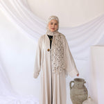 Relaxed-fit linen abaya with understated elegance and spacious, subtle pockets.