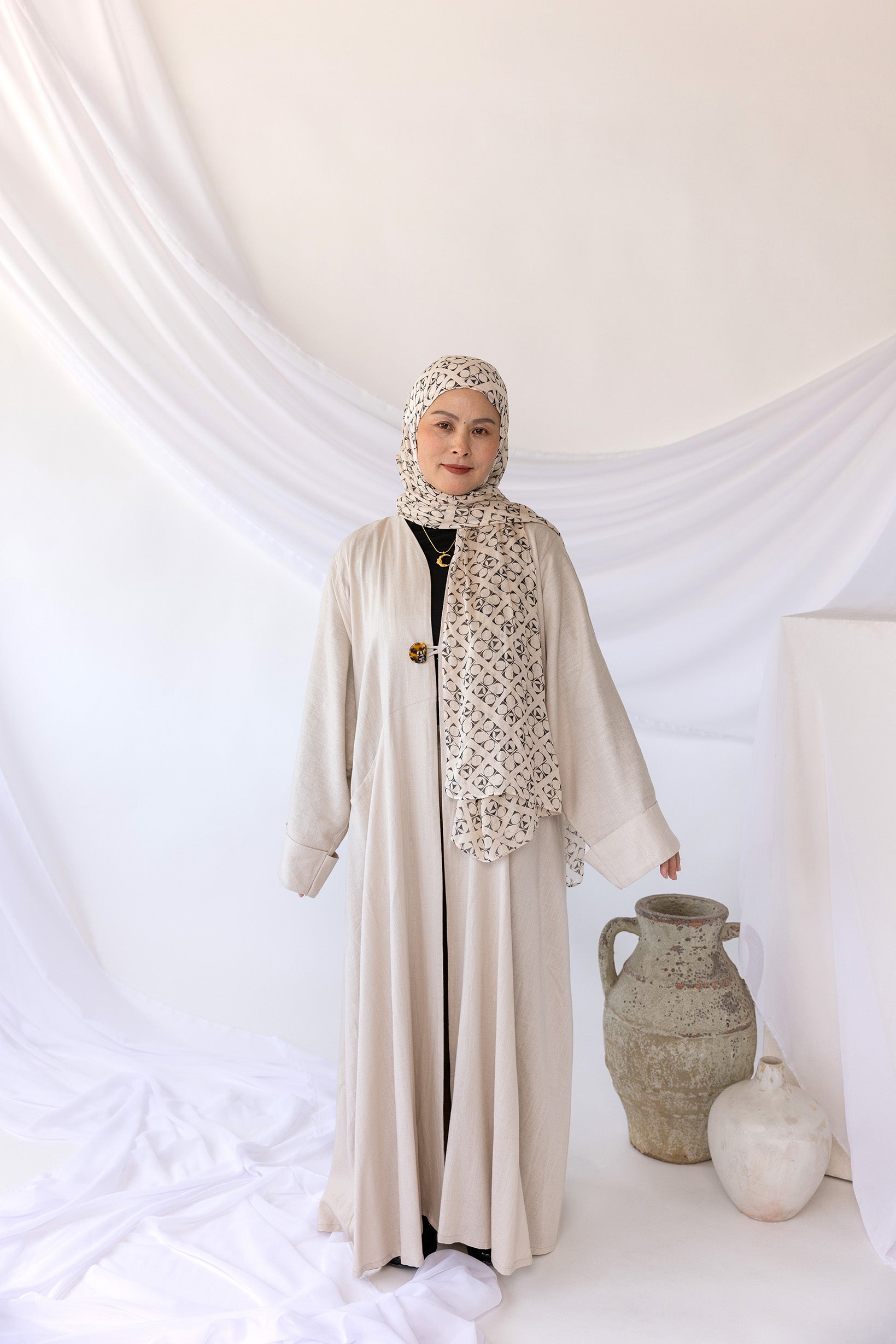 Relaxed-fit linen abaya with understated elegance and spacious, subtle pockets.