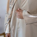 Elegant abaya made from luminous fabric with gentle movement and subtle shine.