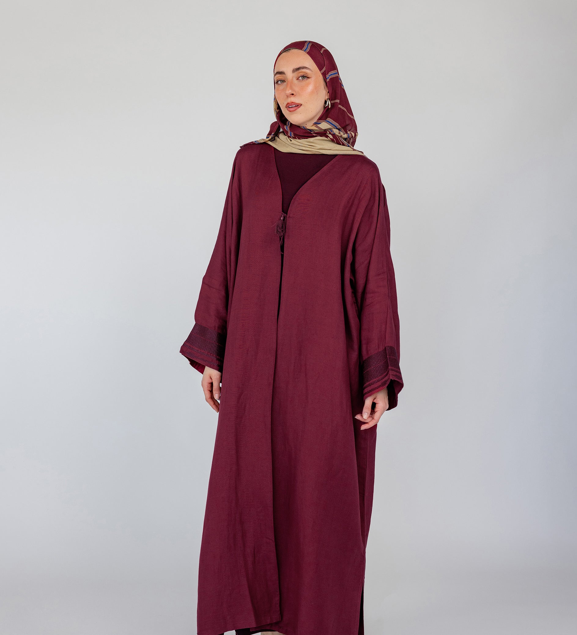 Embroidered abaya with traditional details and a modest silhouette in a soft linen blend
