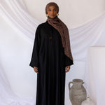 Structured linen abaya offering both comfort and convenience with integrated pockets.