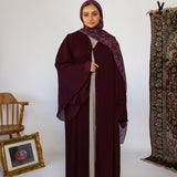 Flowy pleated abaya designed with soft fabric and full-length movement.