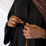 Essential linen abaya with roomy side pockets and a timeless, modest structure.