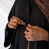 Essential linen abaya with roomy side pockets and a timeless, modest structure.