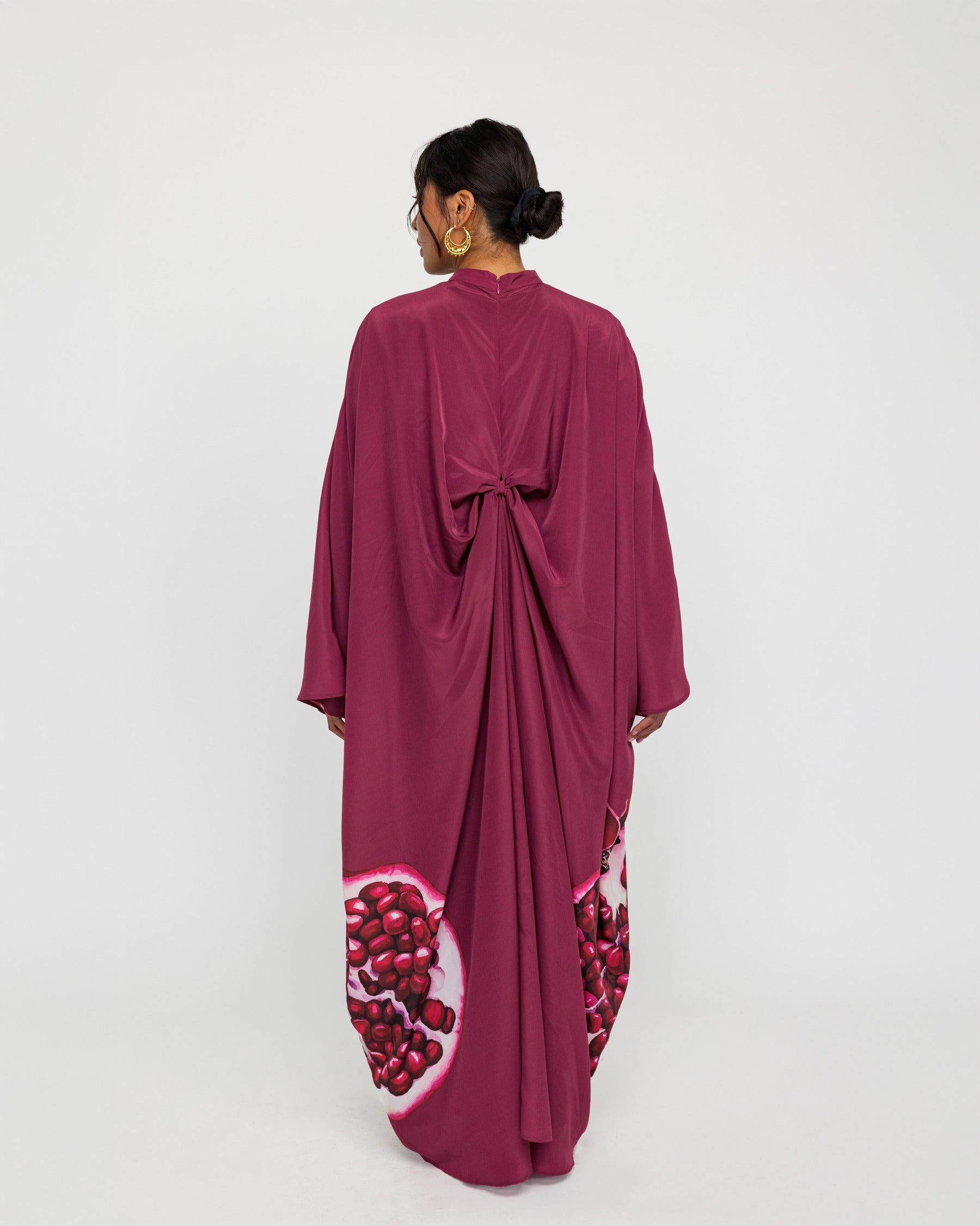 Occasion-ready kaftan with rich drape and subtle nods to traditional symbolism