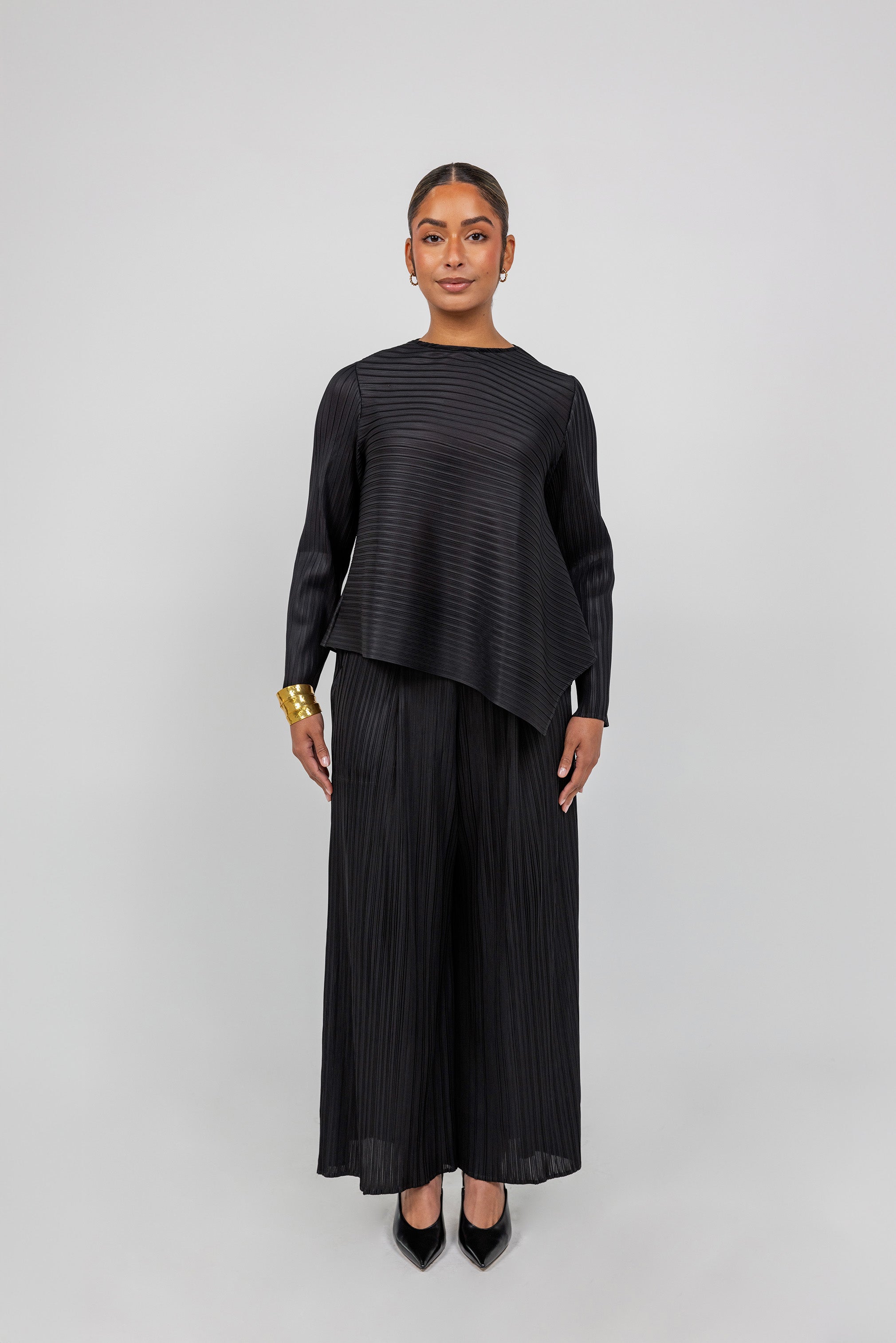 Relaxed-fit pleated top with a modest cut and timeless, structured design.