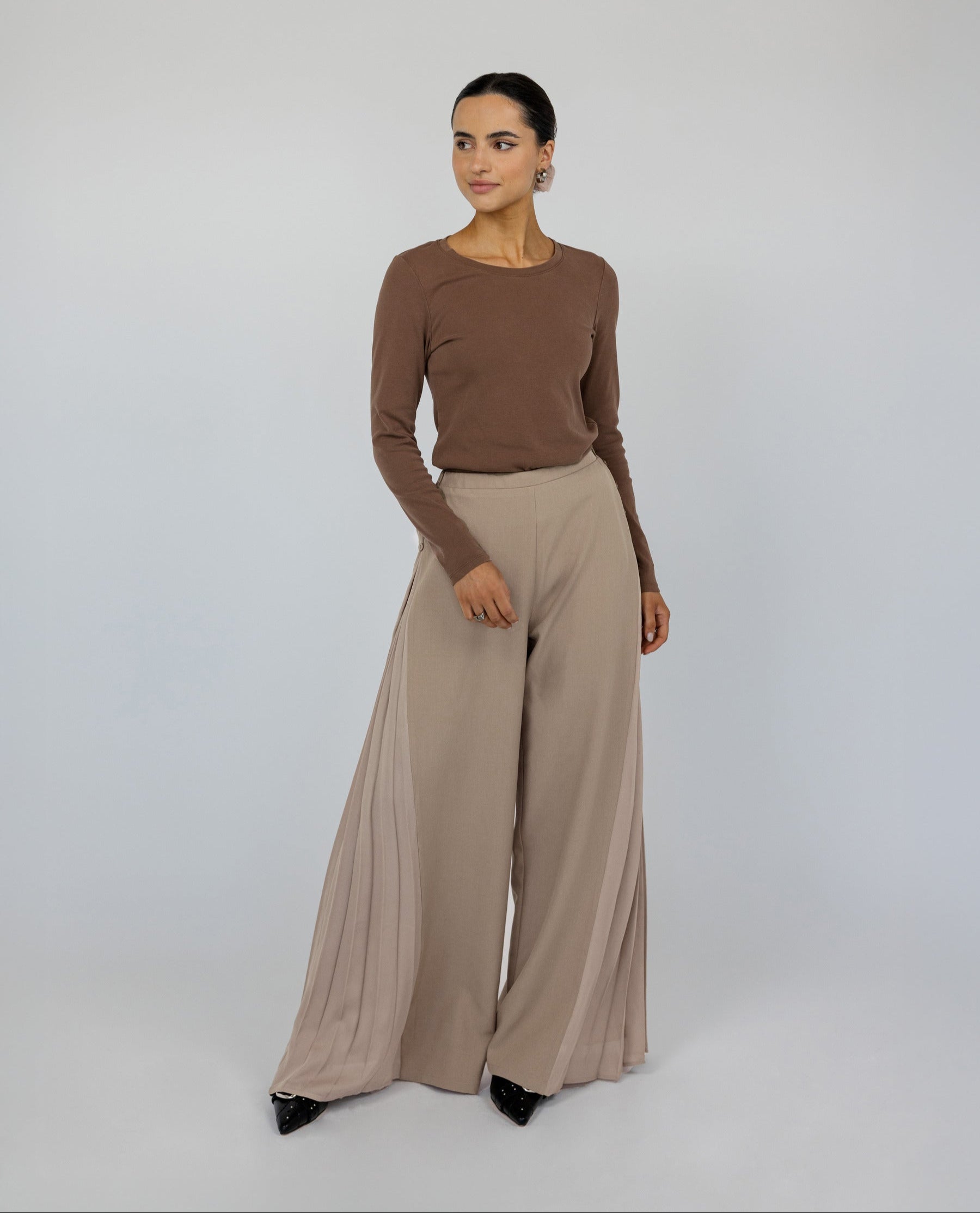 Wide-leg pleated pants with a soft drape and relaxed, modest fit.