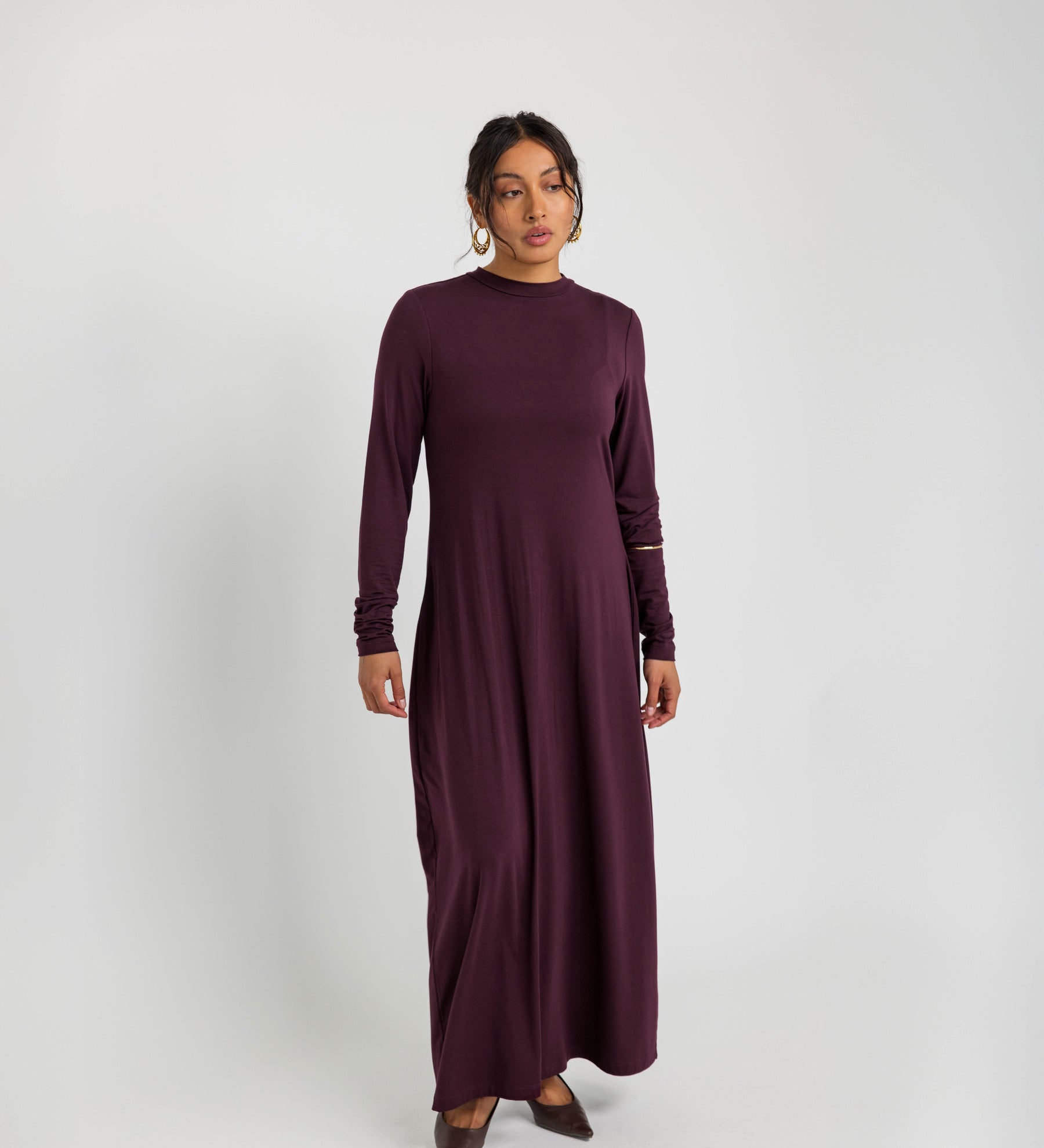 Soft knit under dress designed for layering, with a smooth and flexible fit.