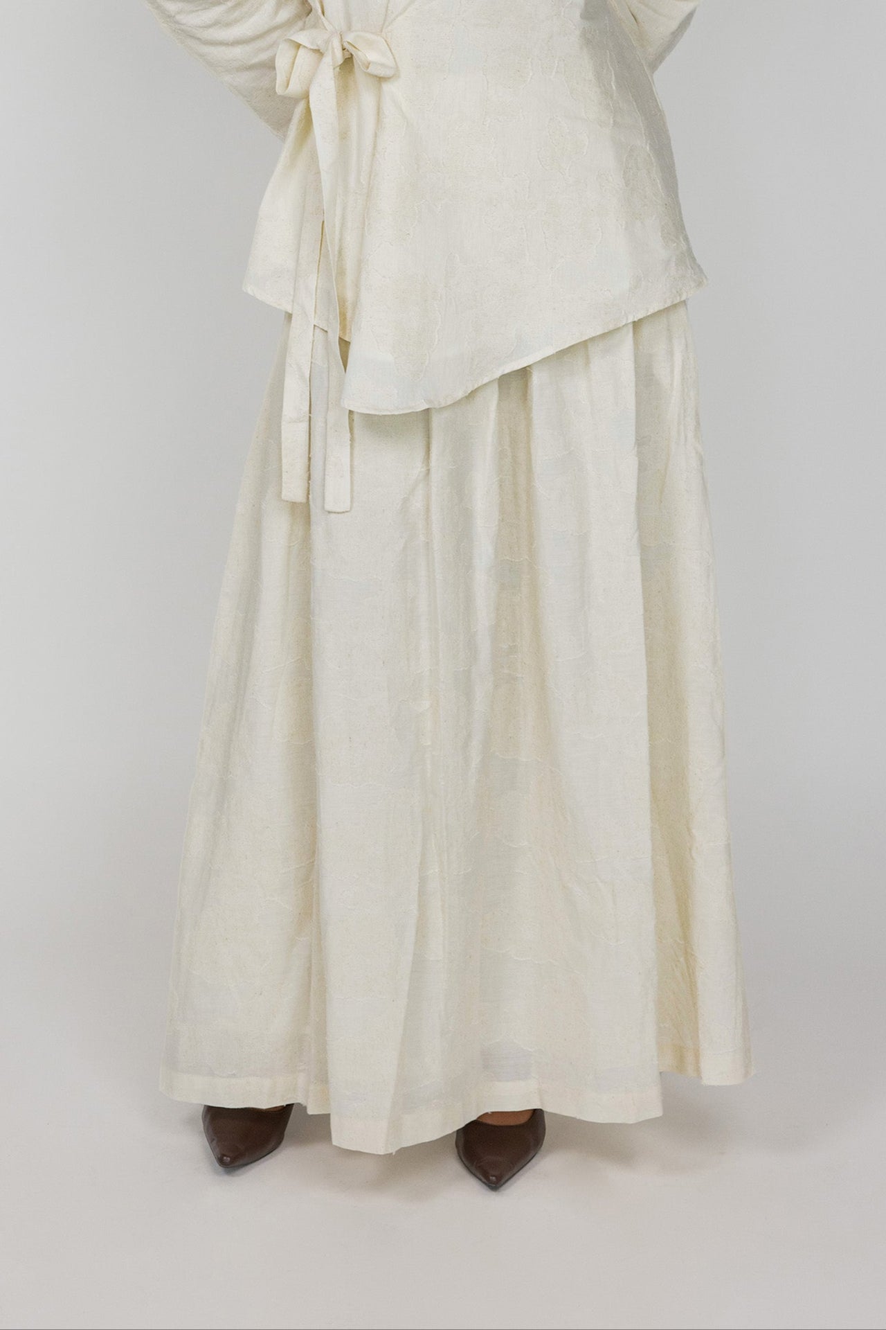 Full-length cream skirt with woven texture, designed for modest and easy styling.