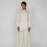 Breathable cream top with floral texture and front tie, made to wear alone or with a matching skirt.