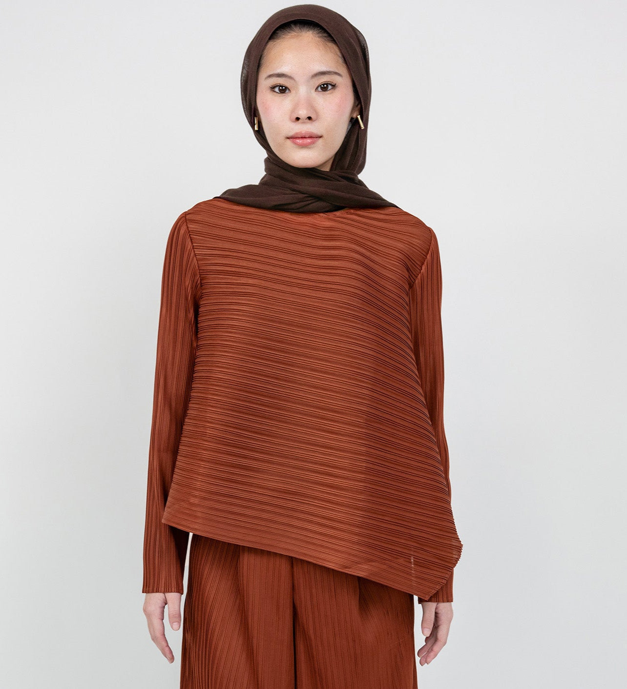 Modest pleated top with fluid lines and relaxed fit for everyday elegance