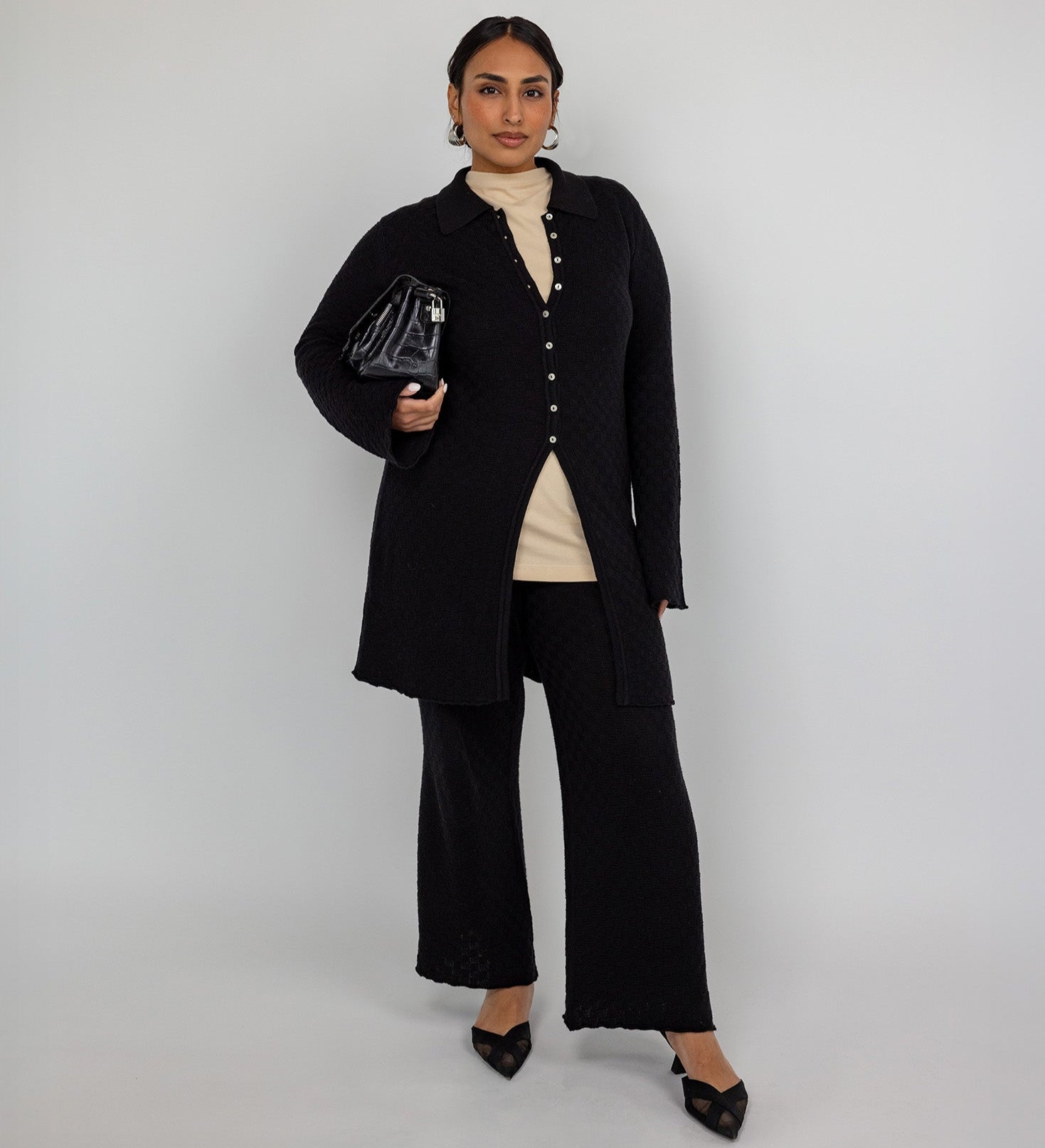 High-waisted flare pants with checkered knit texture and ankle-length finish.