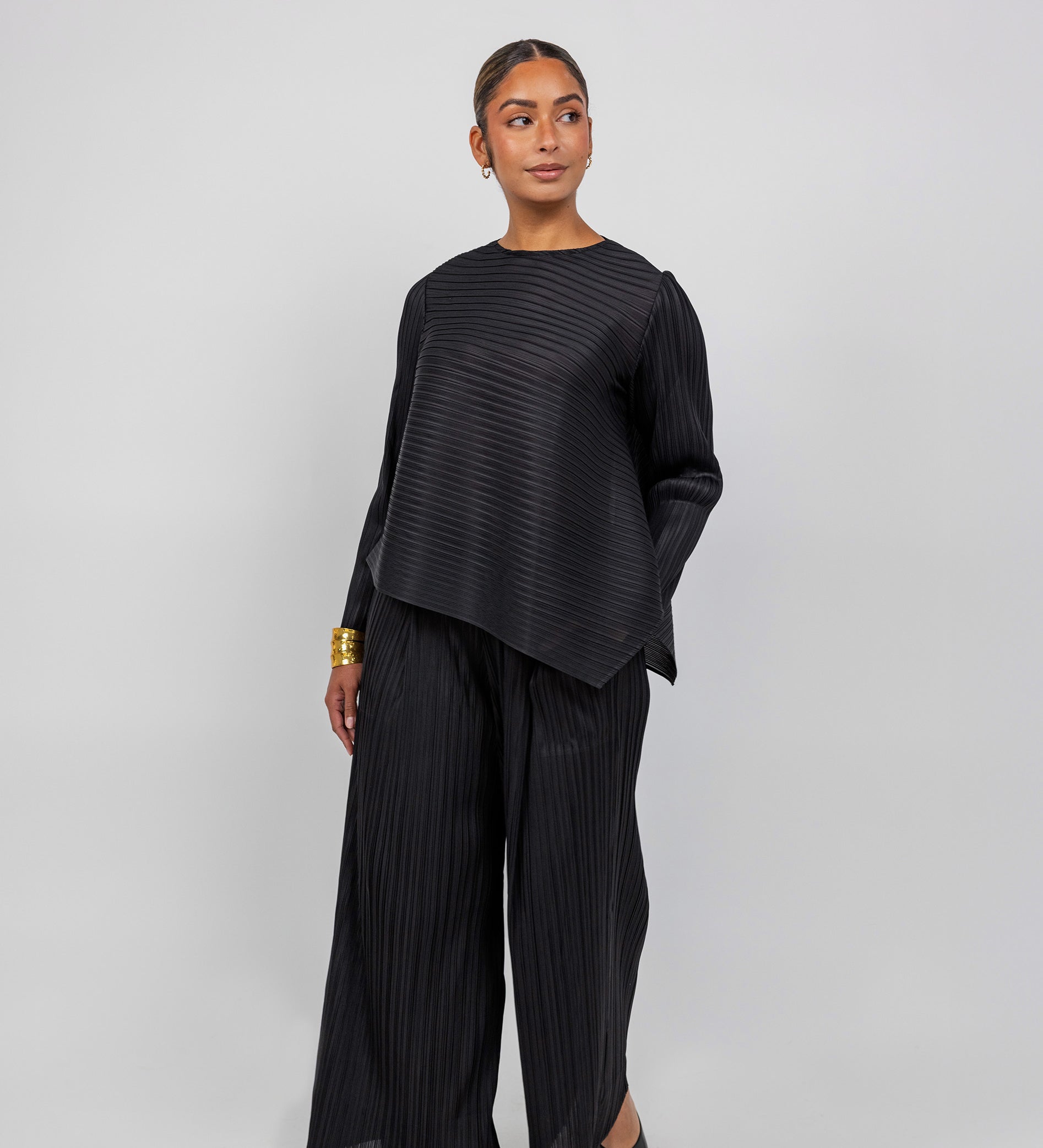 VELA pleated top with gentle texture and flow, designed for movement and ease