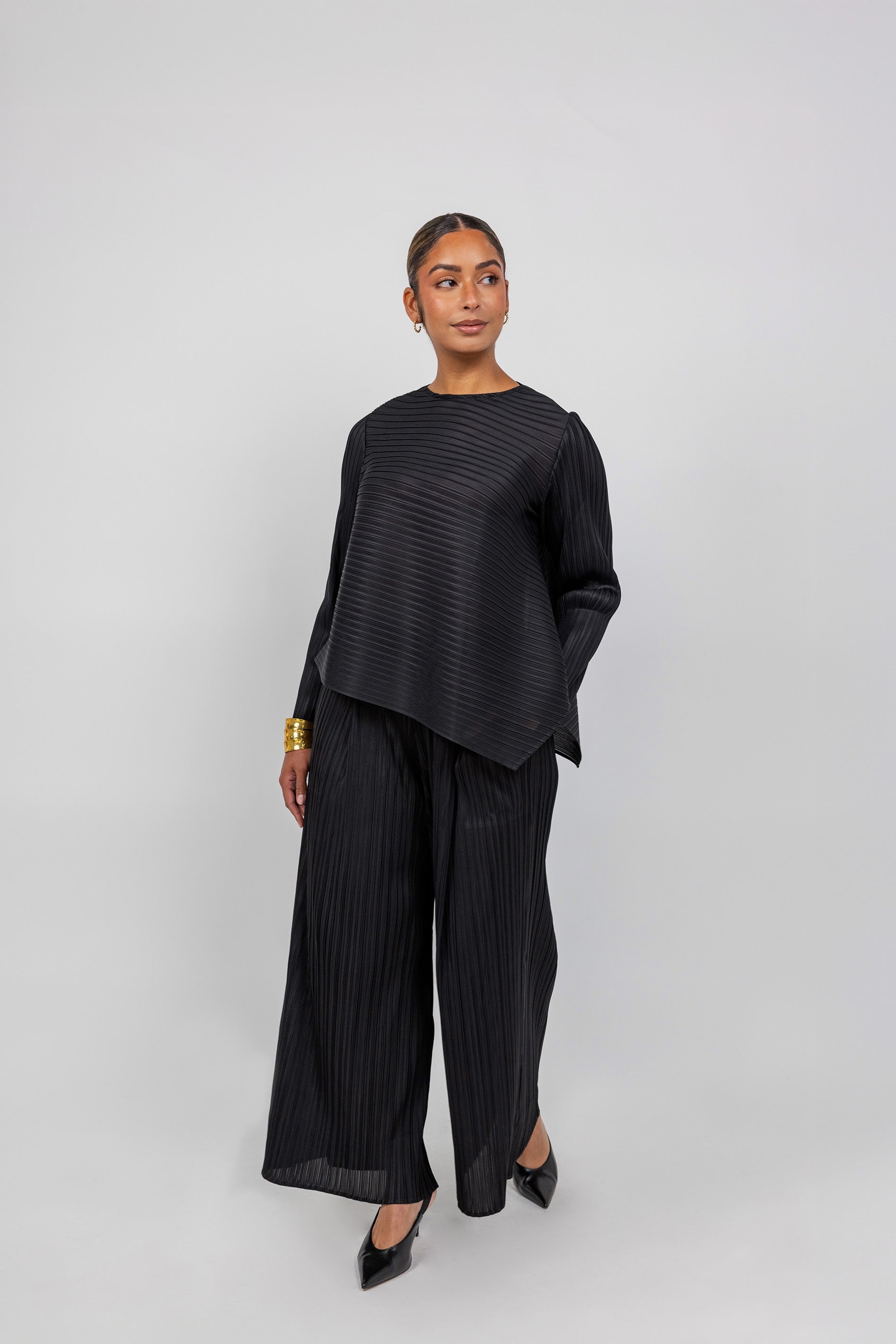 VELA pleated top with gentle texture and flow, designed for movement and ease