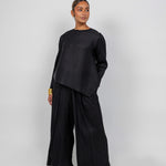 Full-length top with vertical pleats, perfect for pairing with matching pants or layering.