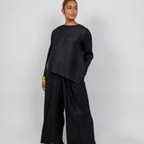 Full-length top with vertical pleats, perfect for pairing with matching pants or layering.
