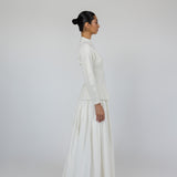 Modest skirt with full pleats and crisp cotton texture, designed to move with ease.