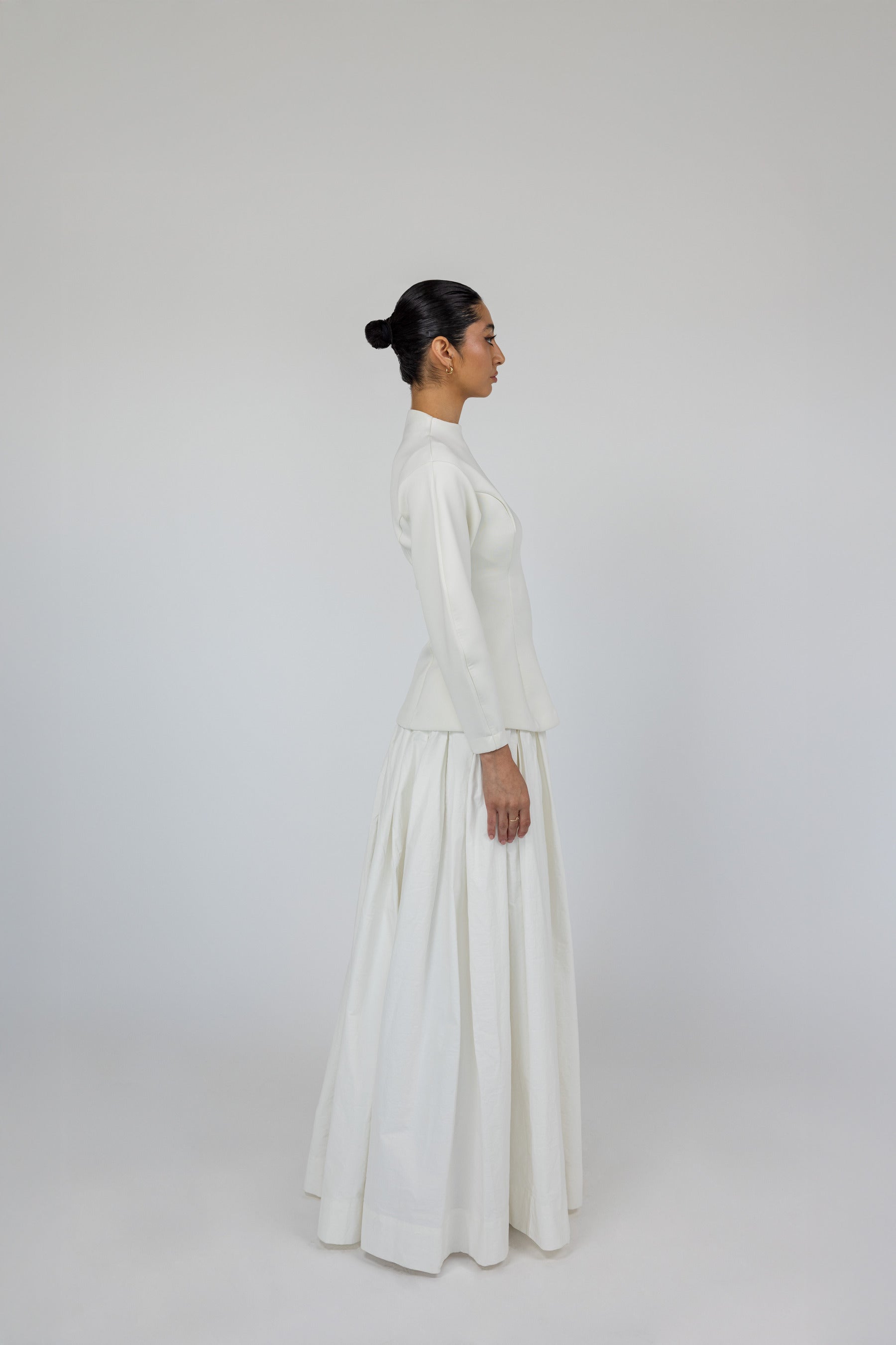 Modest skirt with full pleats and crisp cotton texture, designed to move with ease.