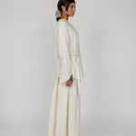 Modest cream top with full coverage and a soft tie-front design, made from textured rayon-linen fabric.