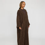 Everyday abaya crafted in structured tweed, offering depth and quiet elegance