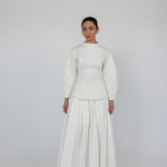 Modest pleated skirt in crisp cotton, offering structured volume and all-day ease