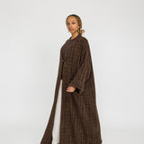 Modest tweed abaya designed with a relaxed fit and rich, woven texture