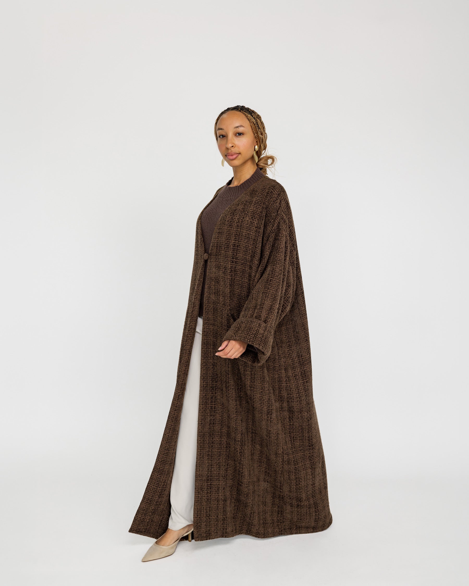 Modest tweed abaya designed with a relaxed fit and rich, woven texture