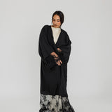 Lace-trimmed abaya with flowing fabric and delicate detailing for a refined finish.