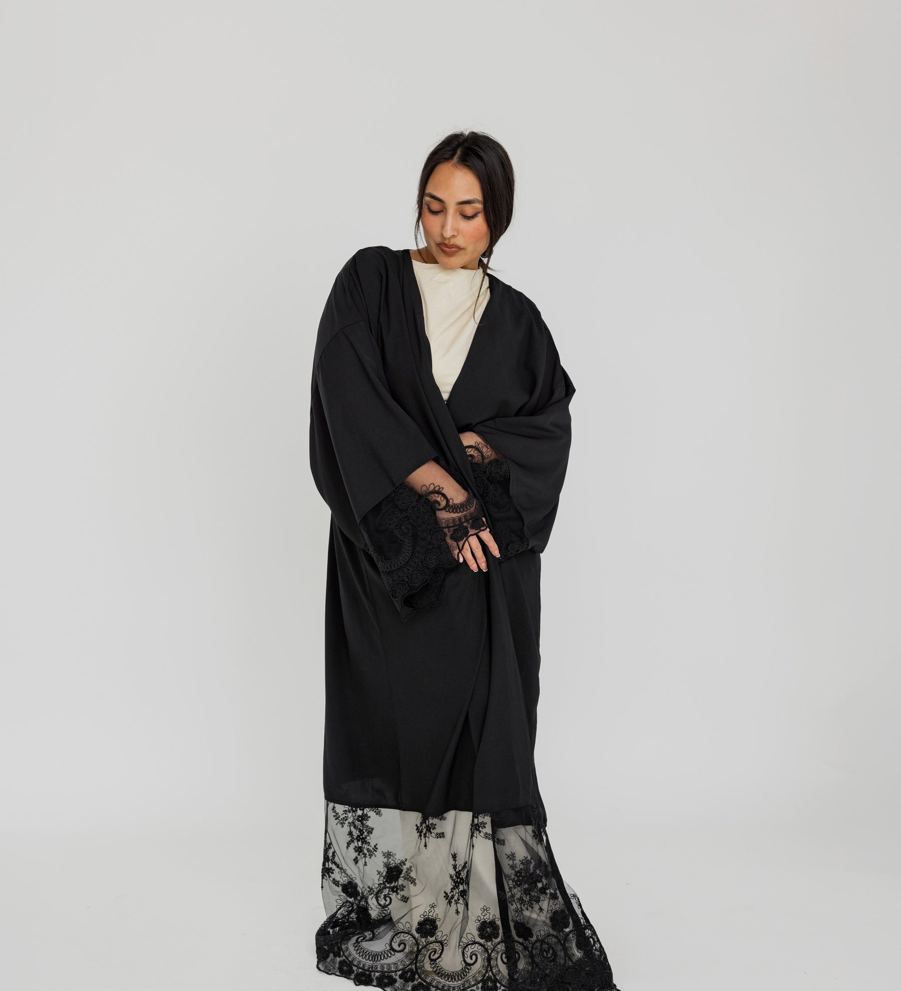 Lace-trimmed abaya with flowing fabric and delicate detailing for a refined finish.